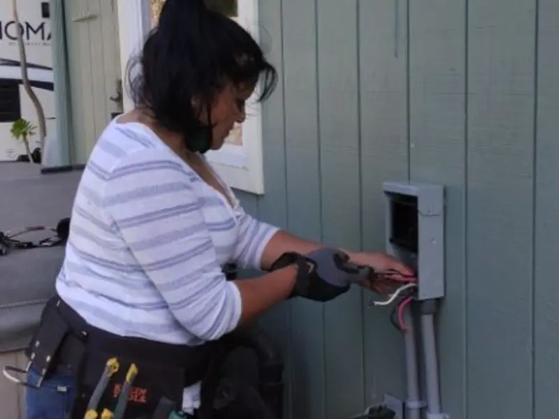 Licensed electrician wiring an exterior subpanel in Silverthorne