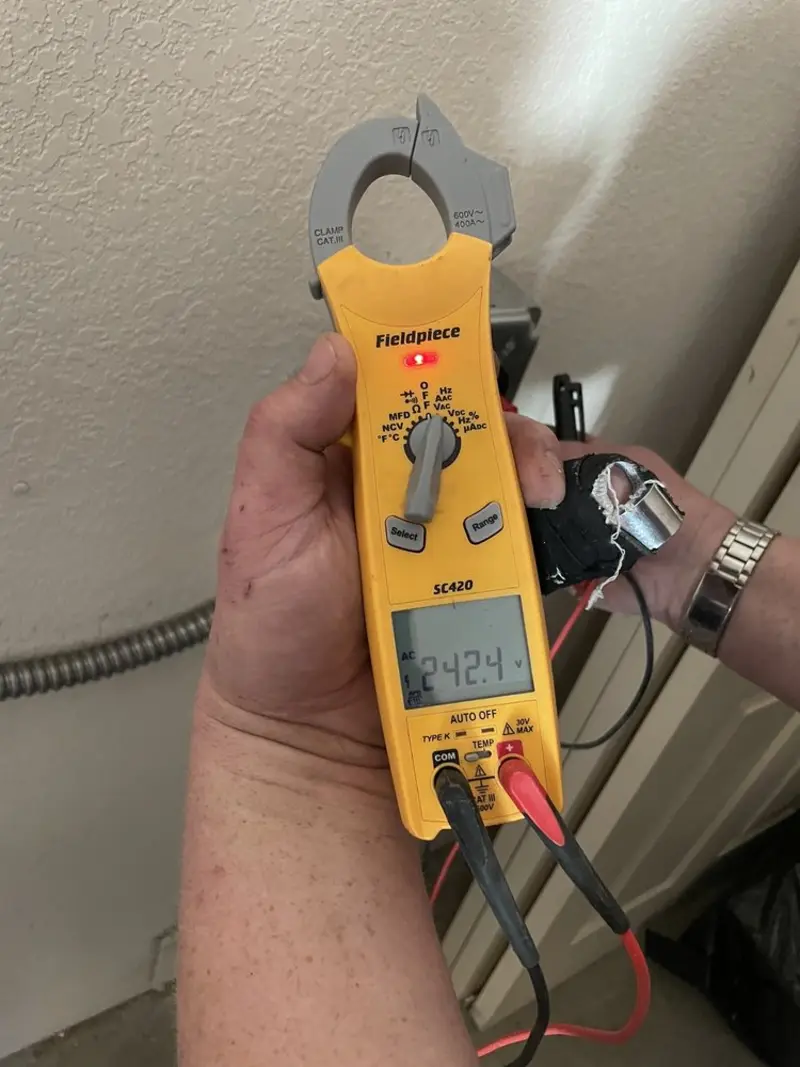 Voltage testing with clamp meter during Outlet Installation in Silverthorne